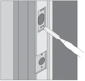 Use chisel and hammer to create mortise for strikes and reinforcement plate